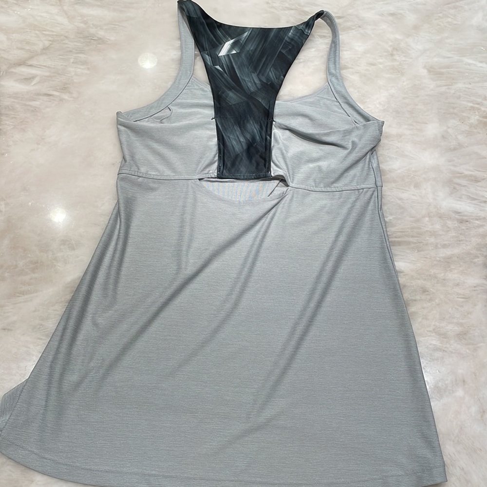 Silver/grey athleisure sports tank with open back cut out. Built in sports bra.